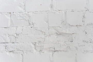 Weathered white brick wall showcasing texture and character over time