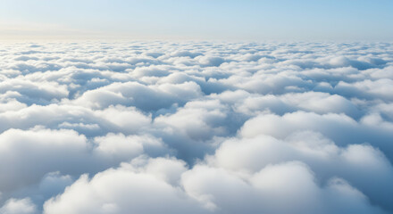 Aerial view of a serene cloudscape with soft fluffy clouds against a blue sky
