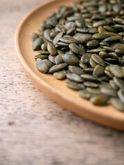 Peeled dry pepita pumpkin seeds background.