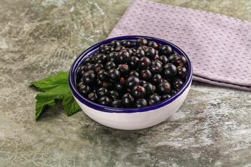 Ripe black currant in the bowl
