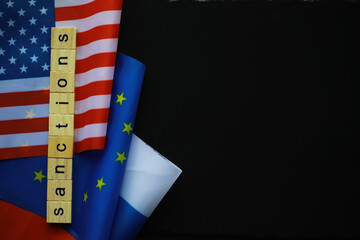 Sanctions Concept with USA, EU, and Russian Flags on Black Background