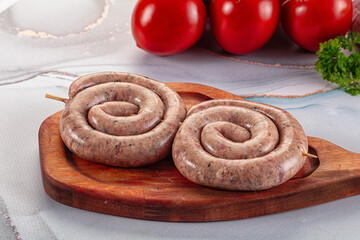 Raw meat pork and beef swirl sausages