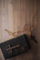 Antique Wooden Cross, Leatherbound Bible, and Rustic Table - Religious Symbolism and Faith