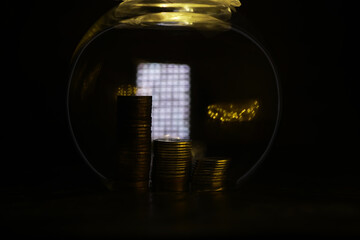 Stacked Gold Coins in Glass Jar with Warm Lighting and Blurred Background