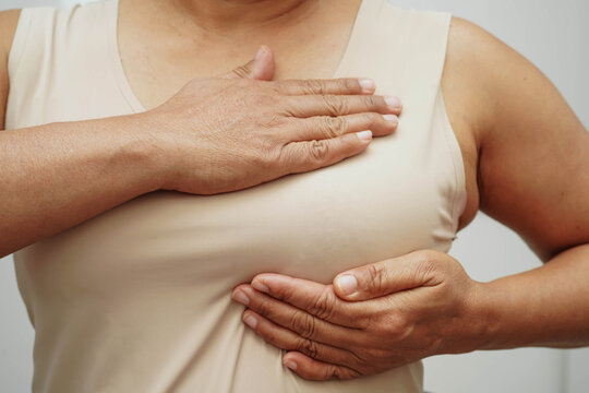 Asian woman self touching check lump or Breast cancer, Breast Self Exam.