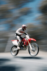 motocross rider captured in dynamic turn displaying slight smile positioned on left side of frame