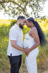 Truly heartwarming scene captures a lovely pregnant African American couple enjoying their blissful summer days together, filled with abundant love and excitement for their future as parents