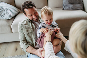 Happy family playing together at home.