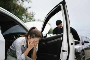 Man inspecting damaged car after crash, documenting insurance claim with mobile phone, showing...