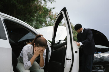 Man inspecting damaged car after crash, documenting insurance claim with mobile phone, showing...