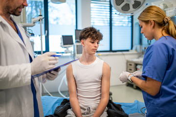 Vaccination of teenage boy during routine health checkup at hospital