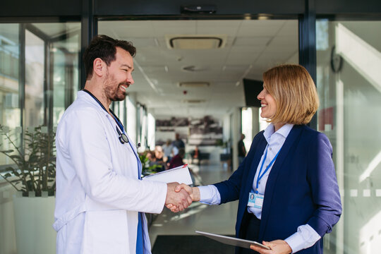 Confident female medical sales representative introducing herself to doctor.