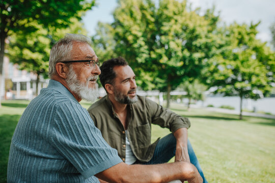 Senior dad and middle-aged son enjoying nature together