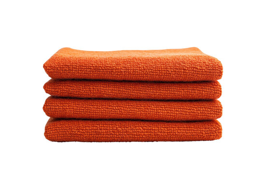 Four burnt orange microfiber cloths stacked neatly