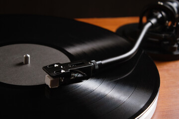 Vinyl record player with black vinyl disc. Classic vinyl record player