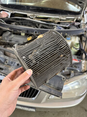 A dirty cabin air filter is replaced in a car. 