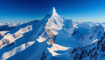 Majestic Snow-Capped Mountain Peak Against a Clear Blue Sky on a Sunny Day