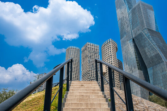 Stairway leading to futuristic towers under blue sky, modern architecture and design elements ideal for corporate, business and urban development stock visuals.