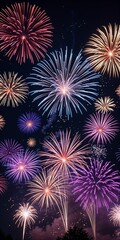 Fototapeta premium Vibrant Fireworks Display in Red, Blue, Purple and Gold Bursting Against a Dark Night Sky