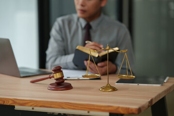 lawyer sits reading a book studying the law in a law office.