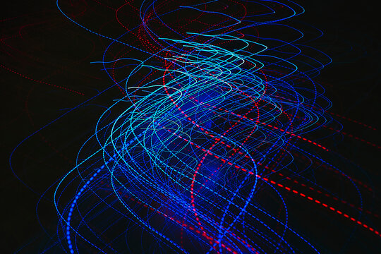 Abstract image of colorful red and blue light trails captured with long exposure.