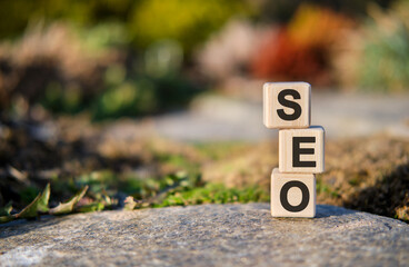 Seo - text on cubes standing on a stone on a natural background