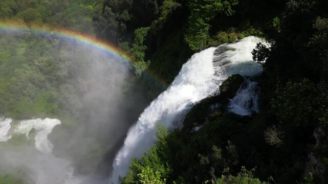  ITALY , drone view of amazing rainbow and waterfall at the Marmore Falls in Umbria Terni - Save the Planet concept and there is not Planet B. spectacular drone footage of wild nature landscape 