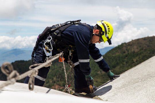 Engineer performing maintenance on a wind turbine nacelle outdoors