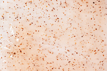 Apricot scrub texture close up. Bright orange smear with exfoliating particles. Natural beauty exfoliating scrubber background. Skincare sugar peeling.