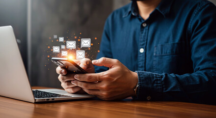 Asian male adult checking email notifications on smartphone in office environment