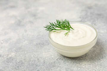 Cucumber sour cream tzatziki sauce on a wooden table.Tartar sauce. Traditional delicious appetizer....
