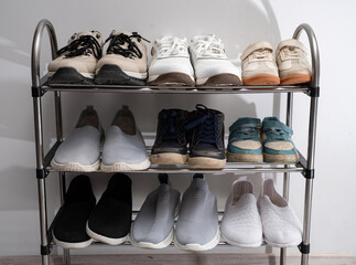 Dirty shoes stand on the shelf. Decluttering and cleaning