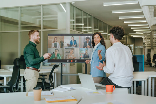 Business colleagues discussing strategy during an online conference in a coworking office