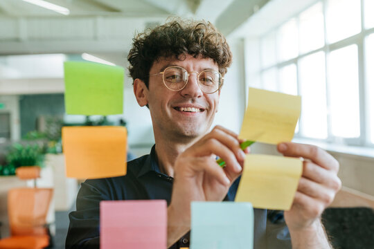 Businessman brainstorming with post-it notes in a modern office
