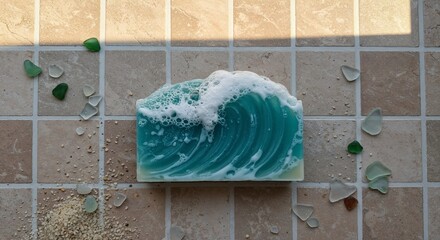 Soap shaped like a wave cresting, semi-translucent with foam detail, displayed on sandy bathroom tiles