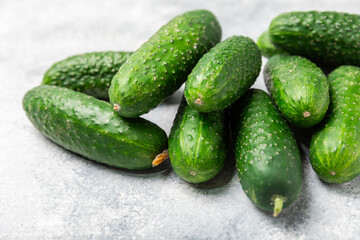 Cucumber on wooden background. Slice of cucumber on background. Fresh organic green cucumbers gherkin. Vegan. Salad ingredient. Farm vegetables. Cut vegetables with knife. Space for text. Copy space