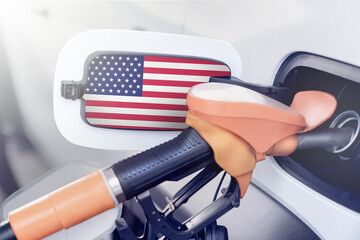 The American flag is on the lid of the gas tank of a car at a gas station. High prices for diesel...