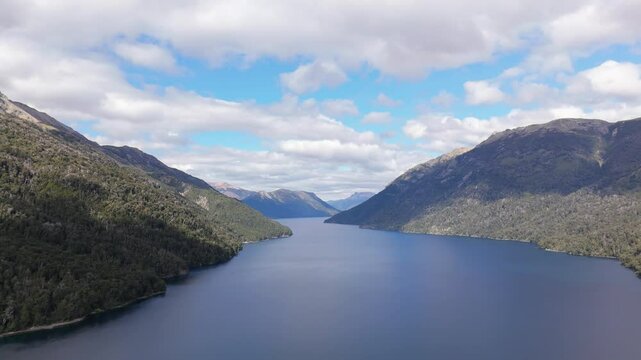 Serene aerial view over Pichi Trafull lake with forested mountains on both sides