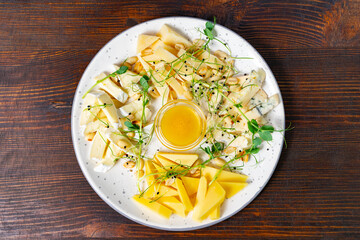 Delightful cheese platter with honey and fresh herbs served elegantly