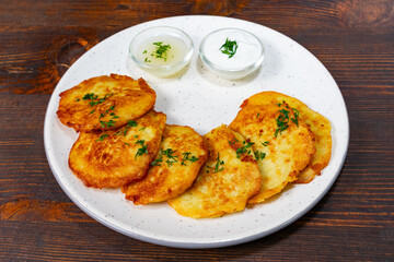 Delicious potato pancakes served with creamy dipping sauces