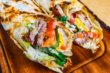 Delicious grilled wrap filled with fresh ingredients and meats