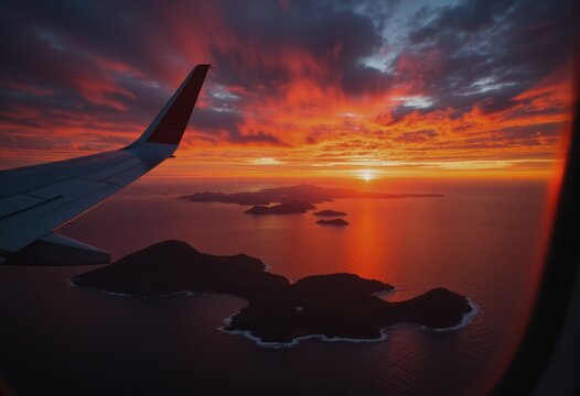 Fototapeta Stunning sunset view of a tropical island seen through an airplane window