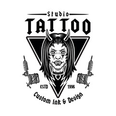 Vintage tattoo studio emblem with devil girl head and tattoo machines. Gothic, old school vector design for tattoo artists, studios, and apparel. Dark, edgy, and artistic illustration in retro style