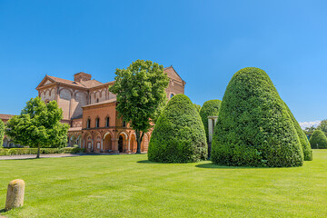 aerial view of Saint Christopher Church and the expansive gardens of the Charterhouse of Ferrara basking in sunlight on clear summer day, offering serene and picturesque view in Ferrara city of Italy