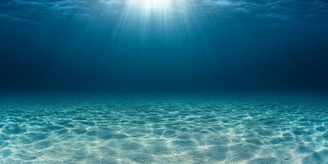Underwater ocean floor with sunlight rays and clear blue water