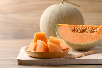 Sliced Orange melon, Musk melon or Flesh melon on wooden plate ready to eating, Fruit in summer season