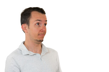 Fototapeta premium Man in white shirt looking surprised or curious to the side. reaction or concept visuals. Isolated portrait. Transparent png.