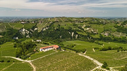 Springtime panorama,  taken by drone, of the hills covered by vineyards, in the vinery region of Langhe (Piedmont, Northern Italy). This area is UNESCO site since 2014 and famous for its red wines.