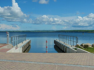 Obraz premium New Slipway at Modern Pier for Boats. Functional construction, clean structure. Space for Texts and designs.