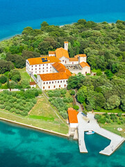 Krk, Croatia. Aerial vertical view of the Franciscan monastery on Košljun Island, surrounded by...